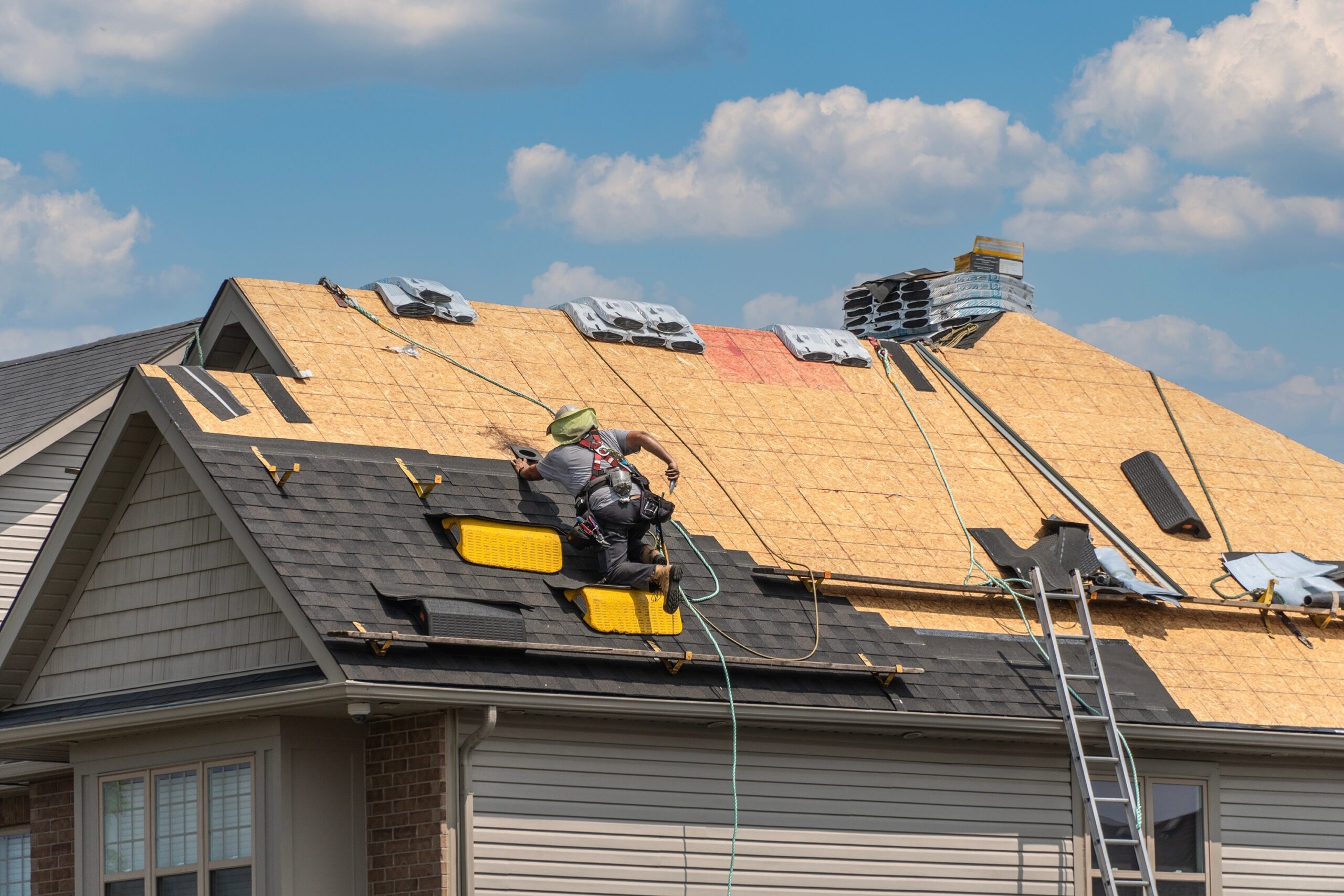 Roofers doing an install of shingles